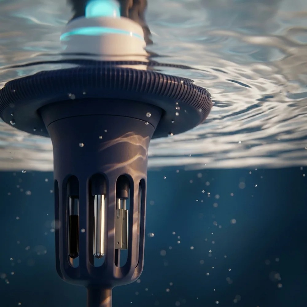 An underwater close-up of the monitor's sensor stem in clear hot tub water: the white body and cyan status ring break the mirrored surface above, the ribbed navy flotation collar spreads at the waterline, and inside the slotted probe guard below it stand three probe tips side by side — a dark glass-tipped pH electrode, a bright platinum ORP electrode and a pair of small facing plates forming the conductivity cell — with sunlight caustics playing across the shell and bubbles drifting past.